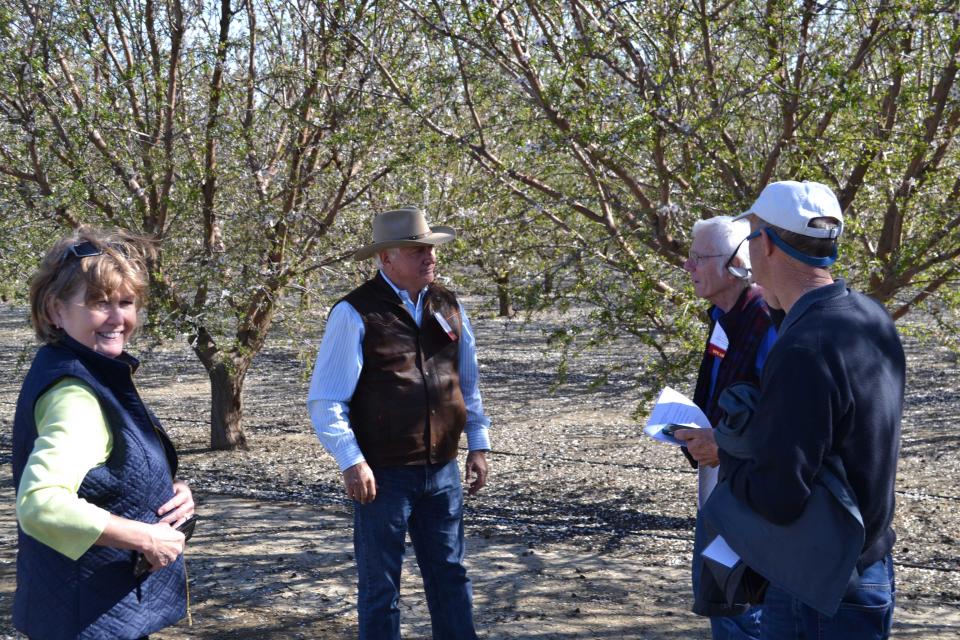 Guests talk with farmer Joe Del Bosque on Central Valley Tour